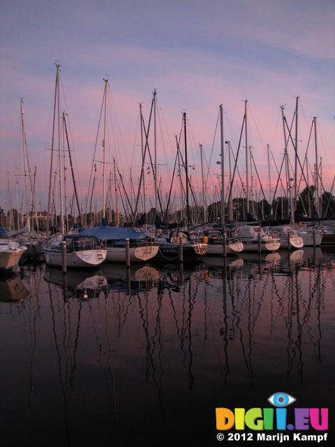 SX24538 Sunset over sailboats in marina at Brouwershaven